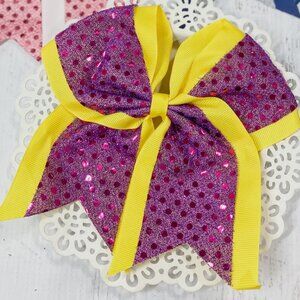 Yellow bow with purple sequins